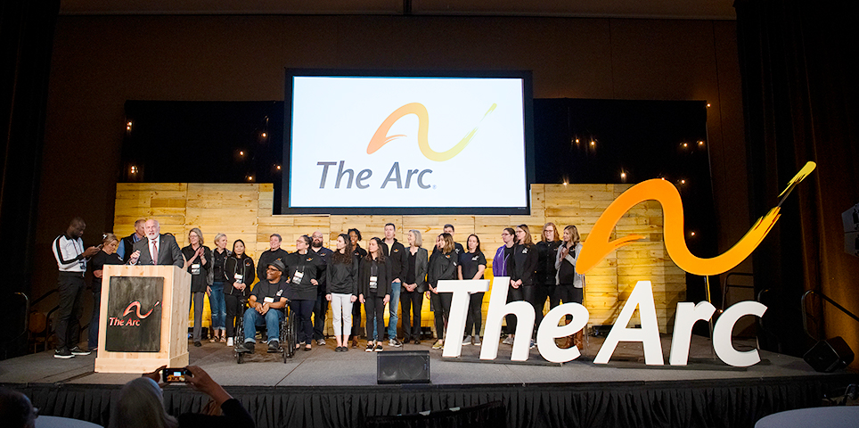 Group of men and women standing on stage at The Arc's National Convention